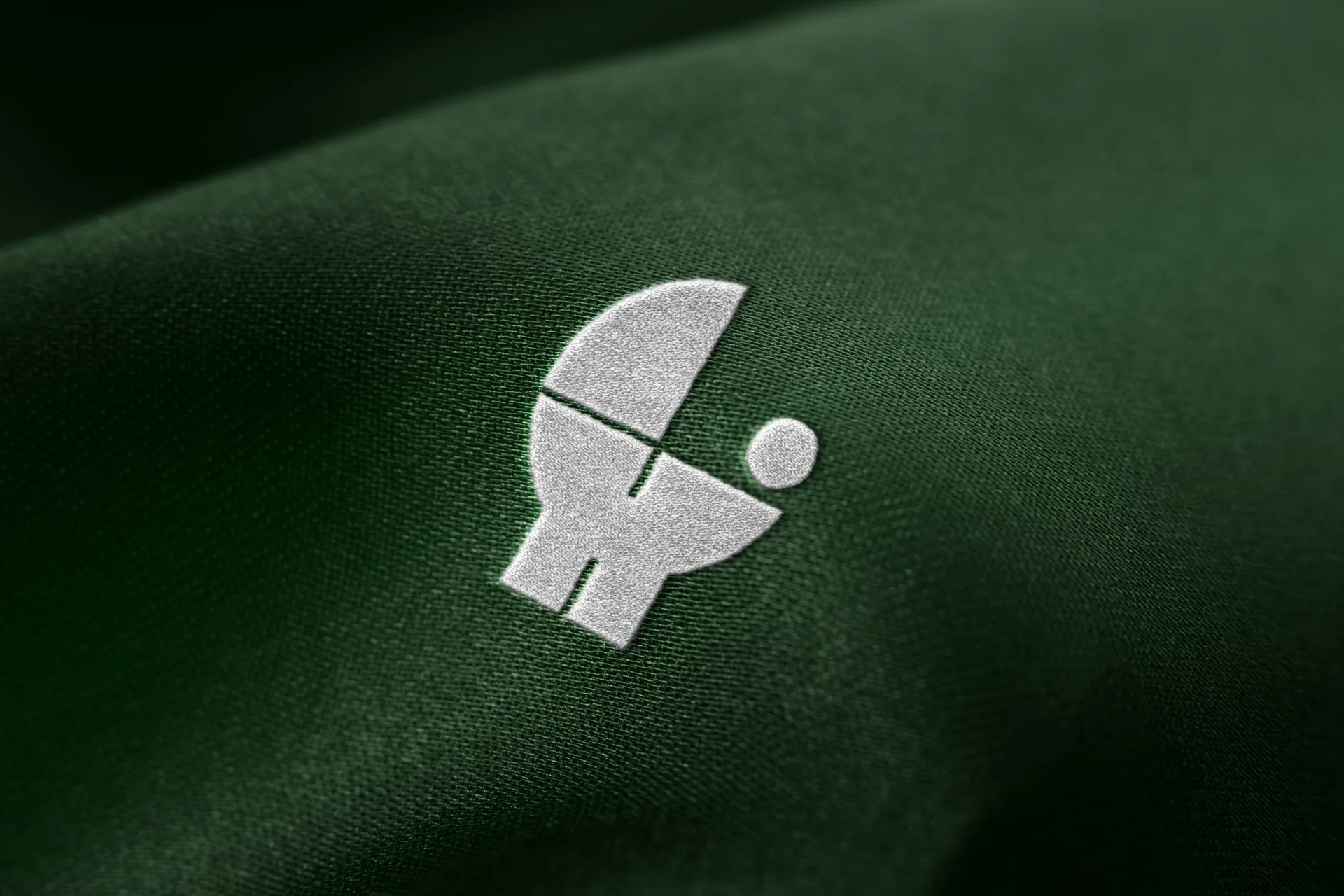Arca symbol embroidered on green fabric