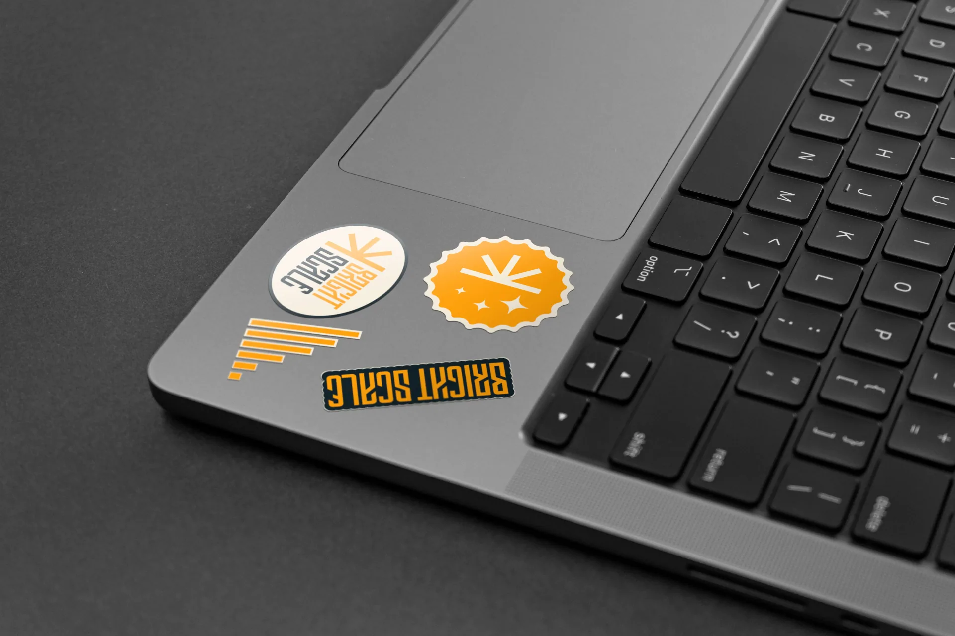 Bright Scale stickers on a laptop