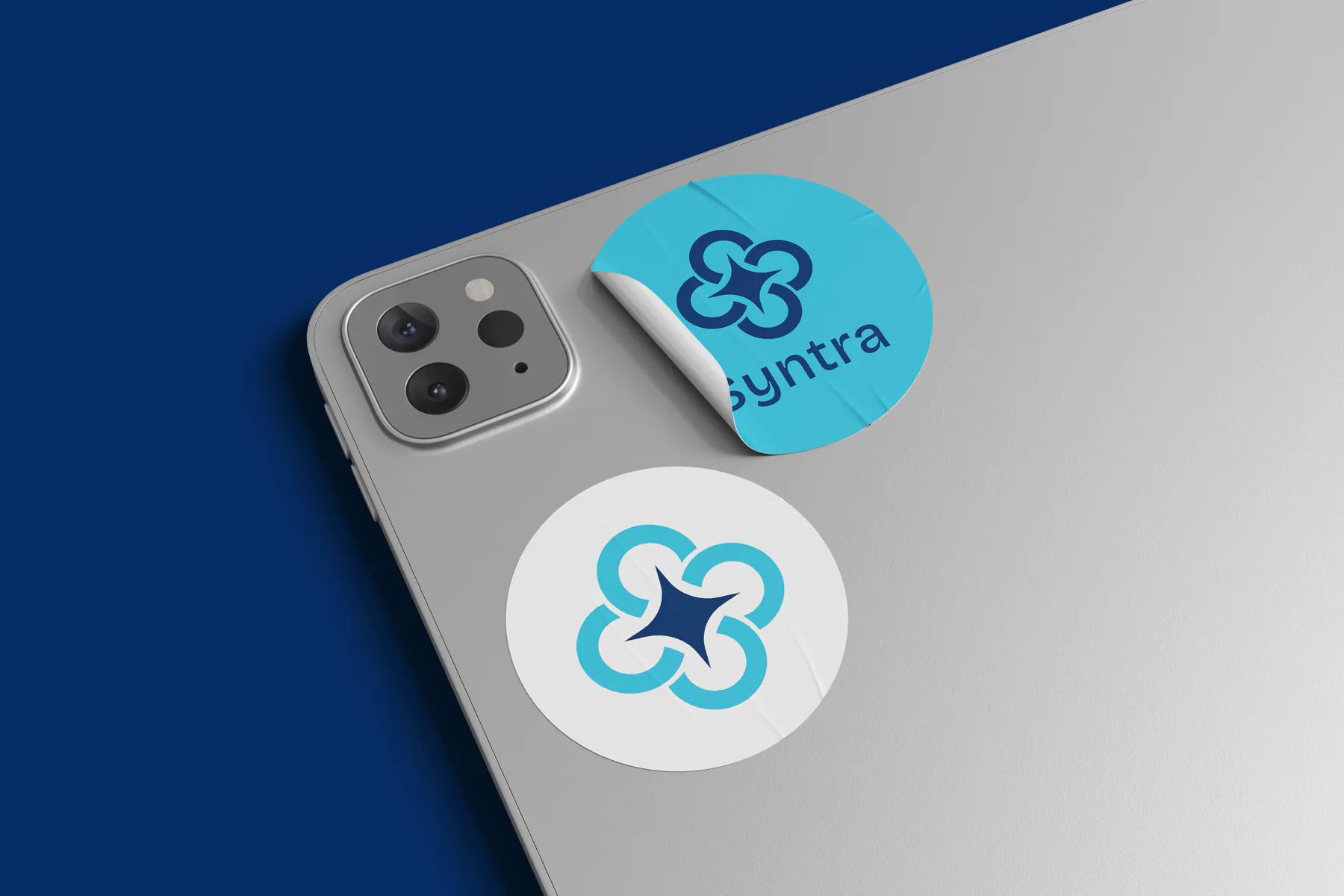 Syntra branded stickers on a tablet