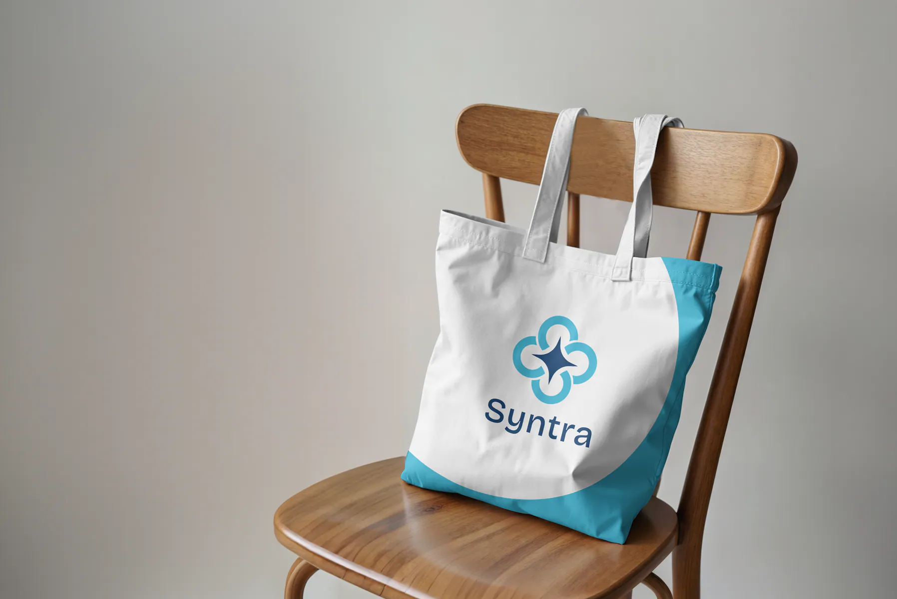 White and blue tote bag featuring the Syntra identity
